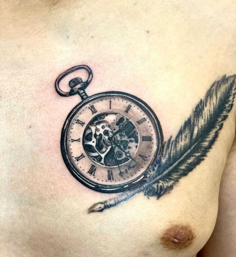 胸に羽と懐中時計のタトゥー