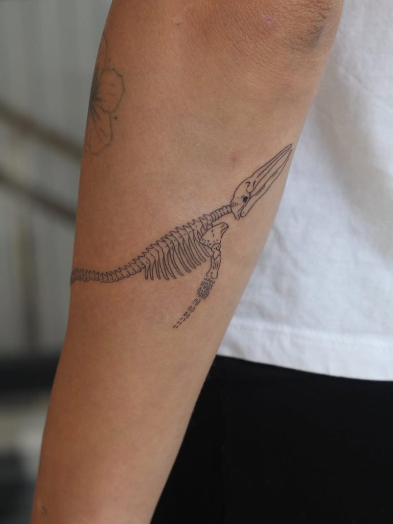 腕にシンプルな鯨(クジラ)の骨のタトゥー