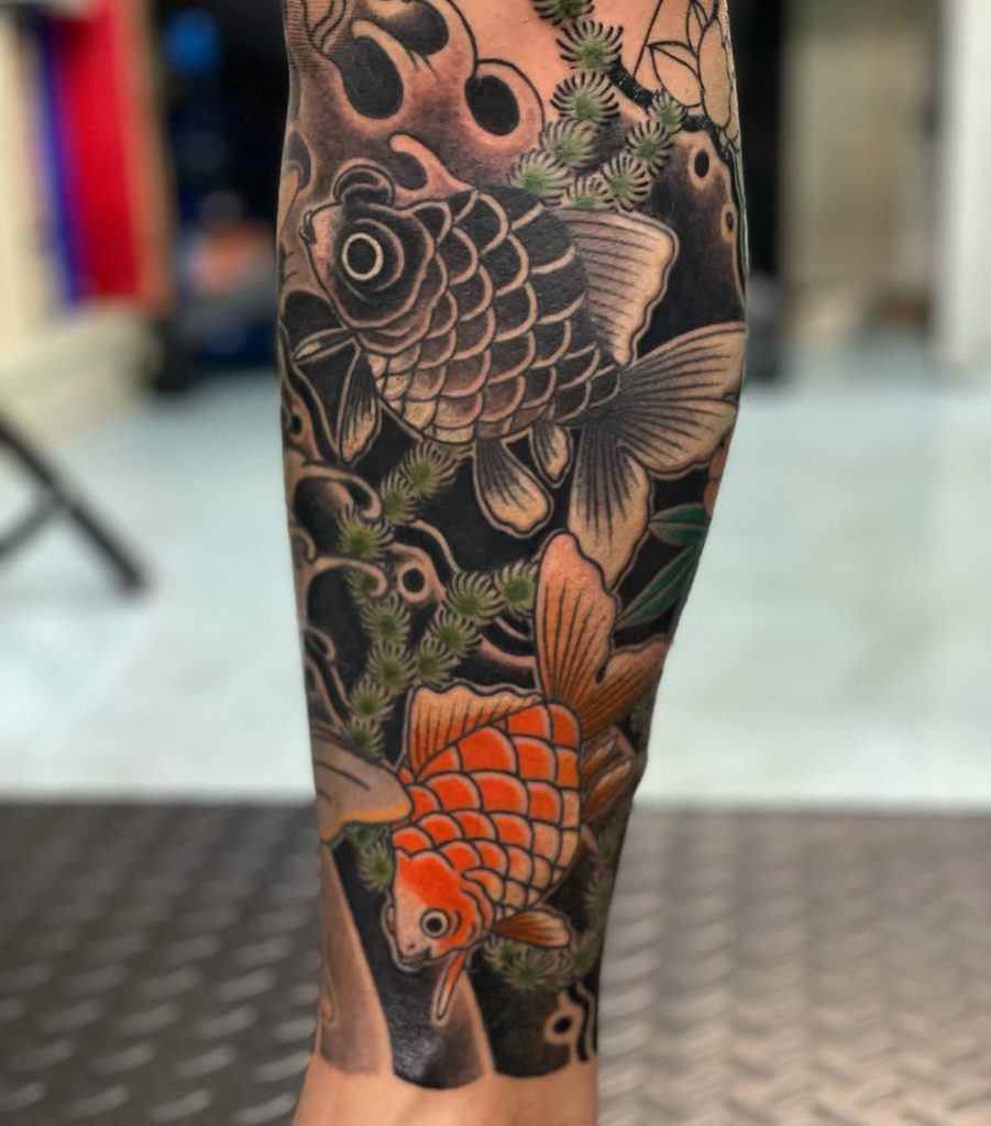 An irezumi-inspired goldfish tattoo in black and vermilion