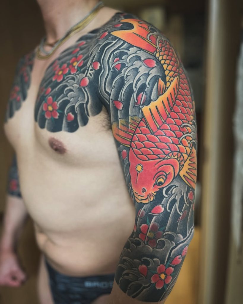 腕から胸にかけて鯉と桜を描いた七分袖の刺青